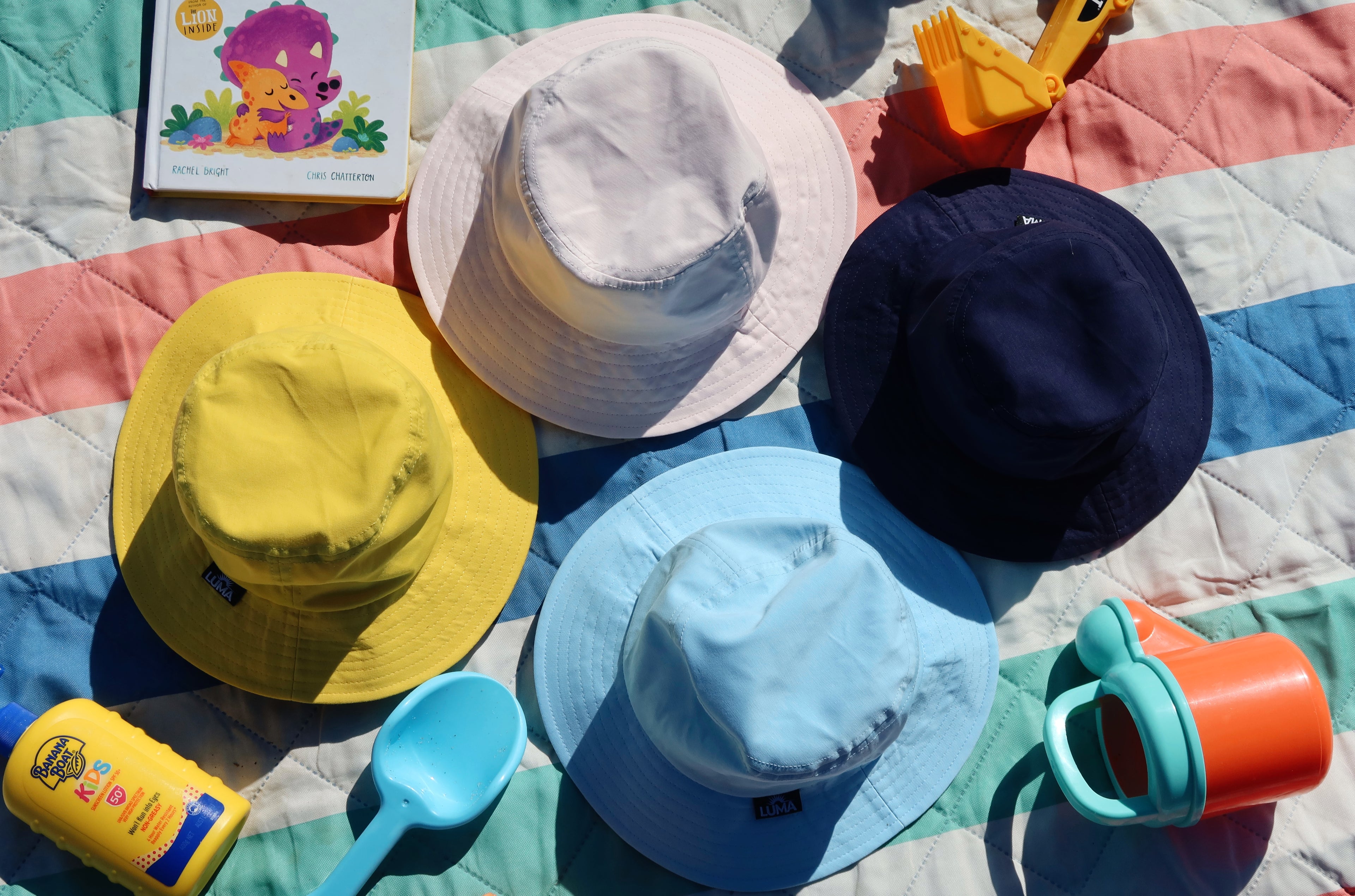 Load video: This video shows kids pulling off their old hats before the Luma hat is secured on each child&#39;s head via the buckle. Parents are left to relax, while the kids play with their hats on.